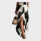 Eleganten dolgi plašč z modernim dizajnom in brezčasno eleganco